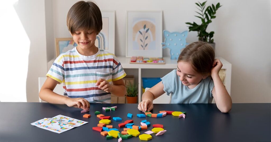 Two children playing with puzzle pieces in a game-based learning environment.