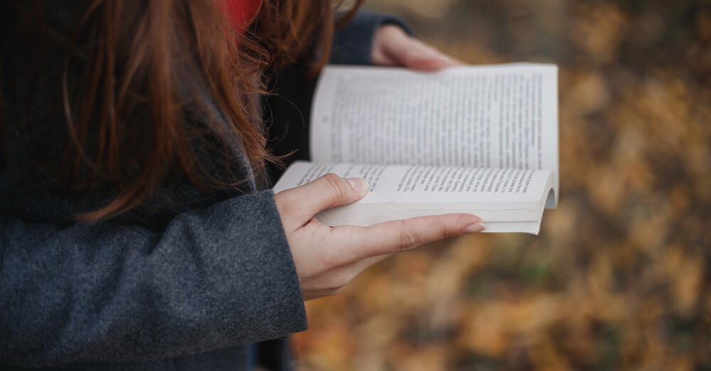 girl holding a women's fiction book