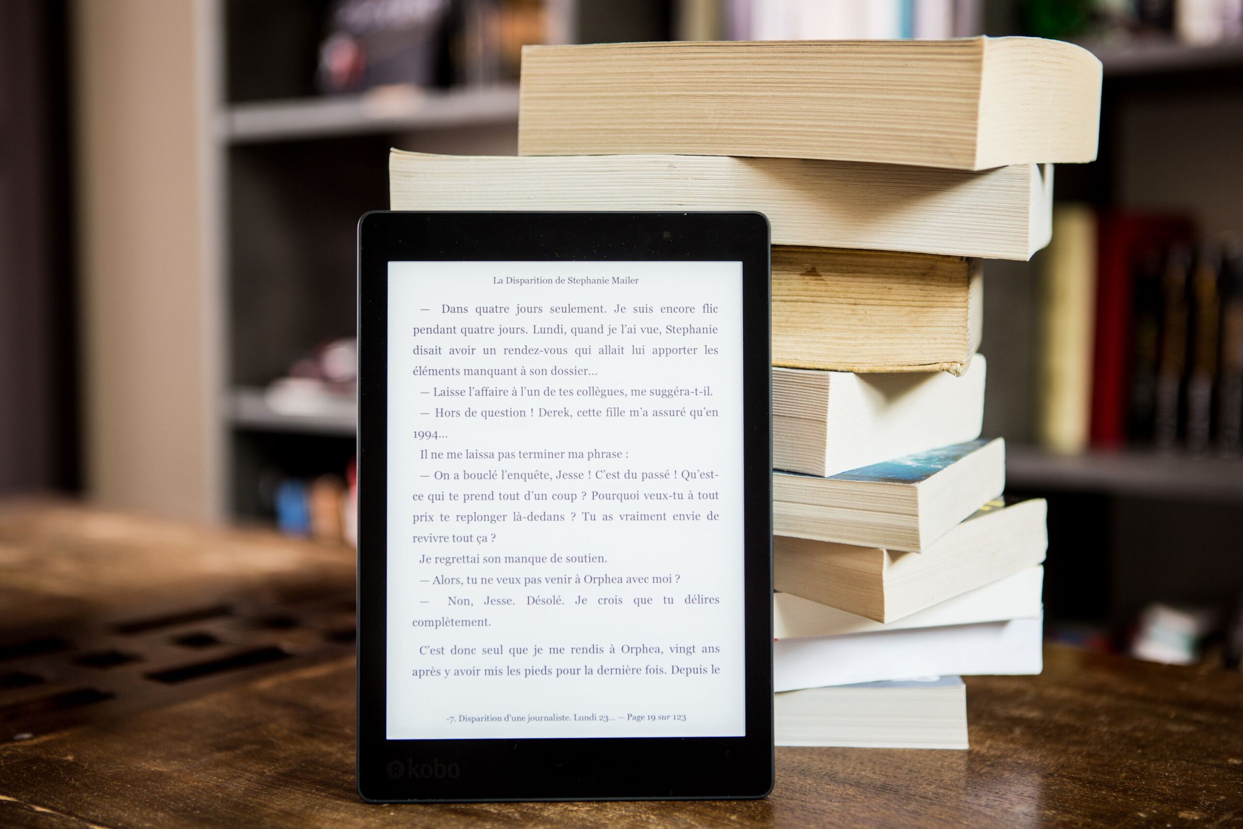 E-reader standing infront of a pile of books